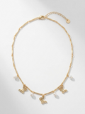 Butterfly charm, pearl accents, and gold-tone necklace