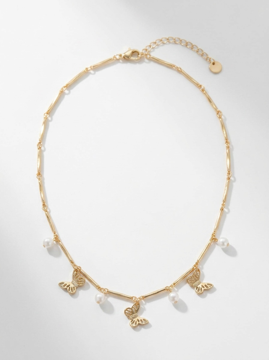 Butterfly charm, pearl accents, and gold-tone necklace